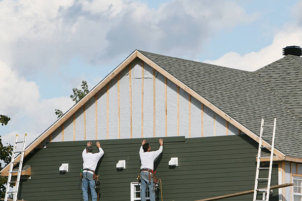 Professional Storm Damage Siding Repair technician working in Paris, OH